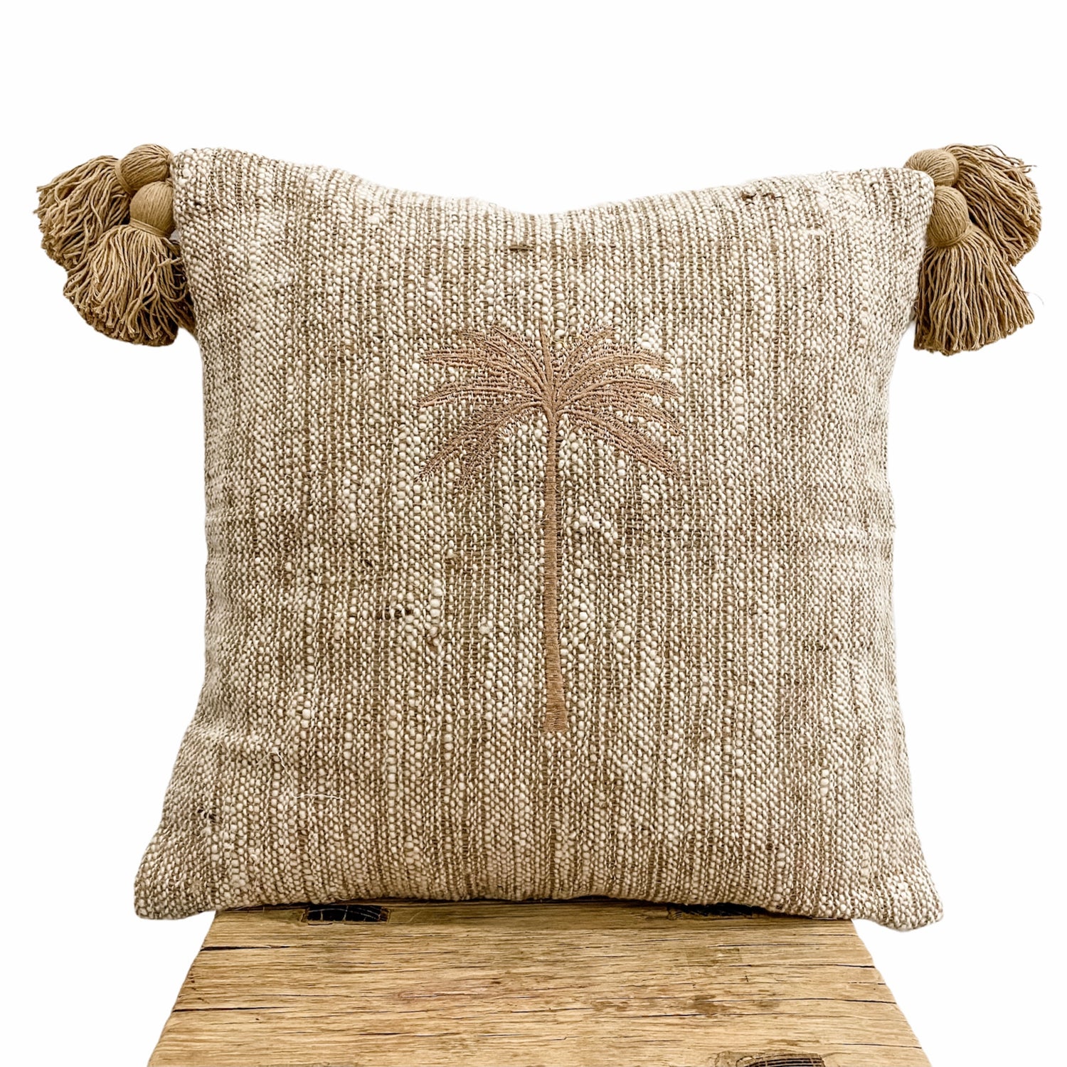 Husk Cushion featuring tassels and palm